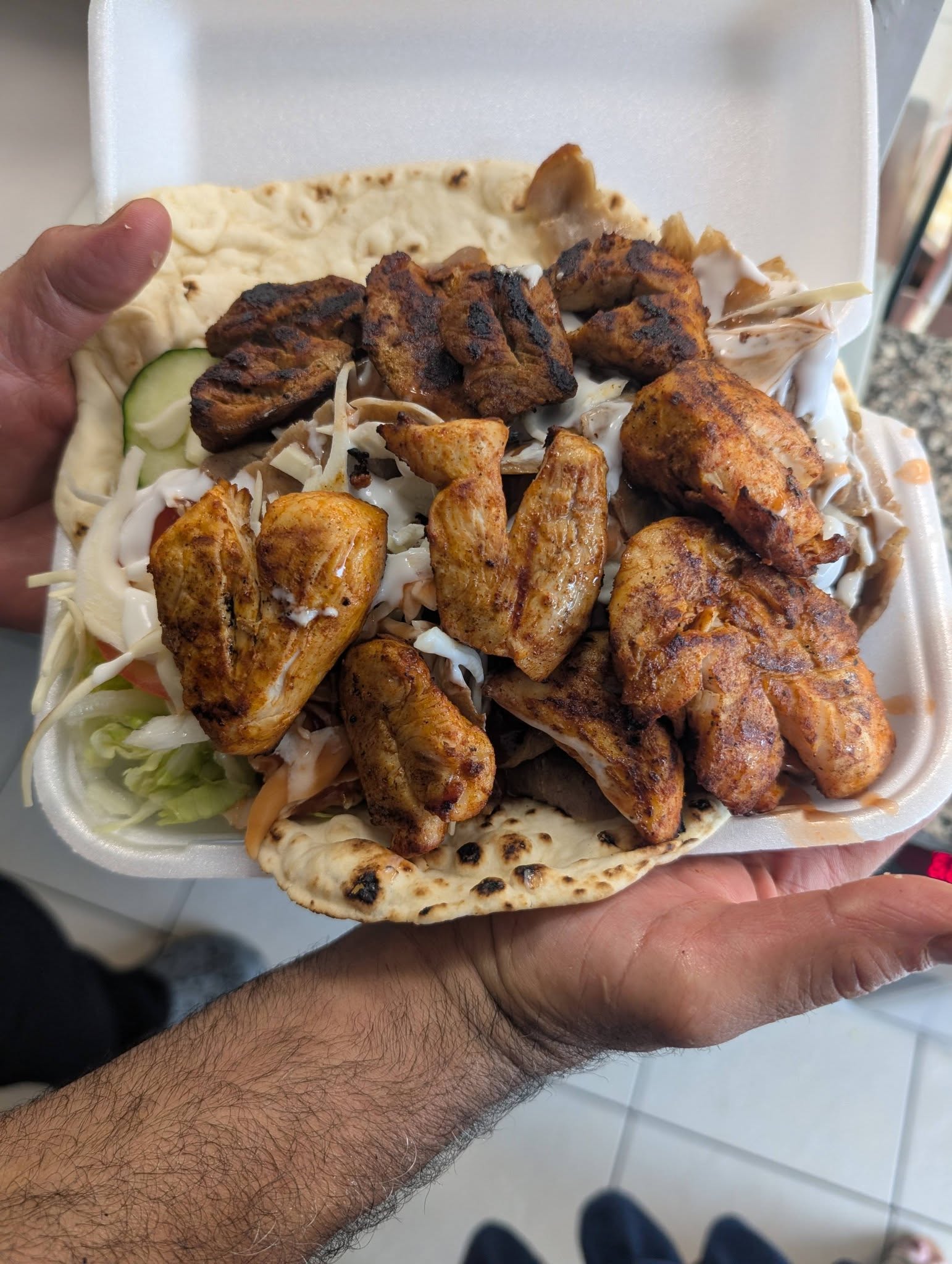 Grilled chicken kebab open wrap piled high with salad and sauce