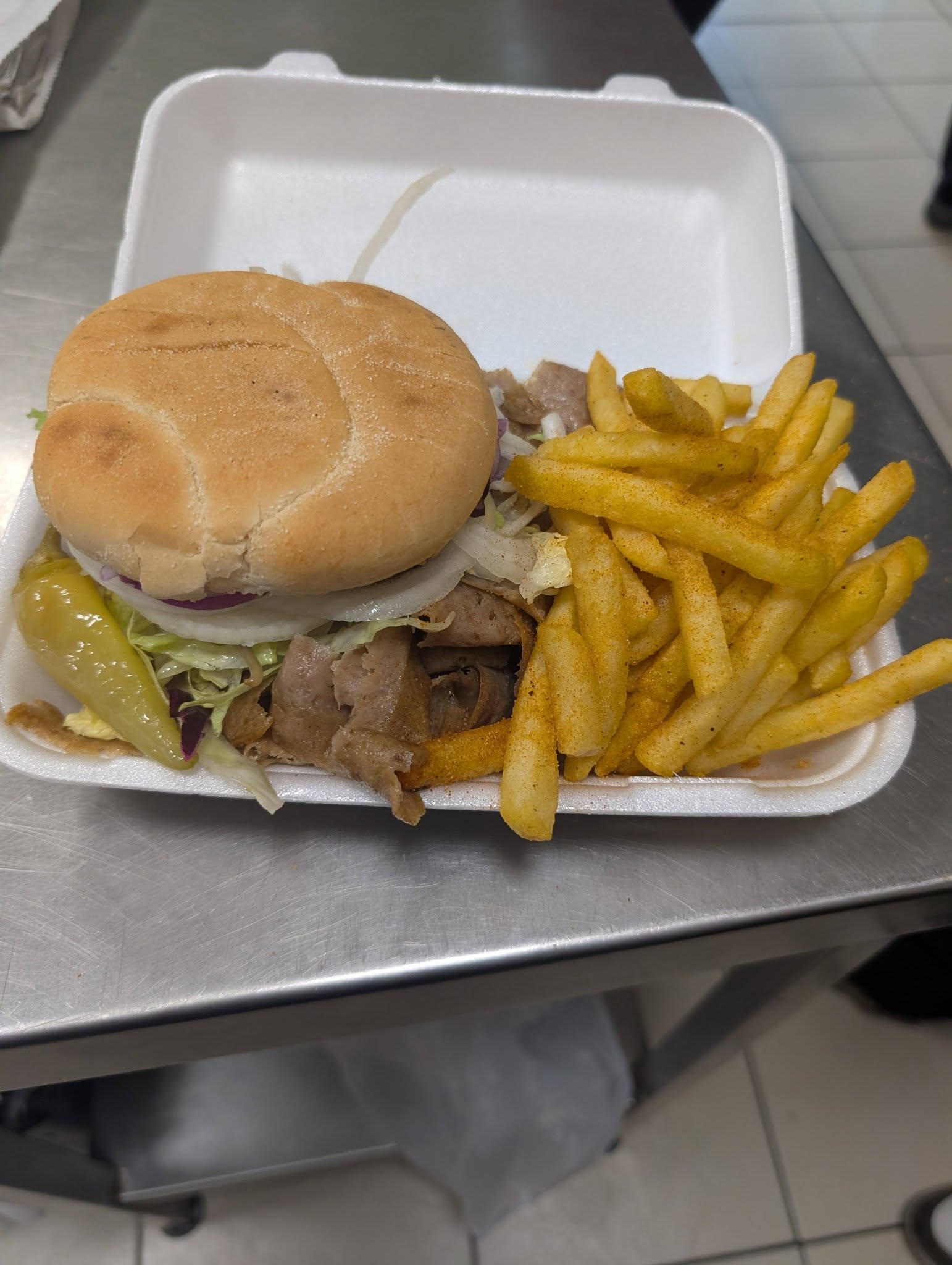 Doner kebab burger with salad and seasoned chips